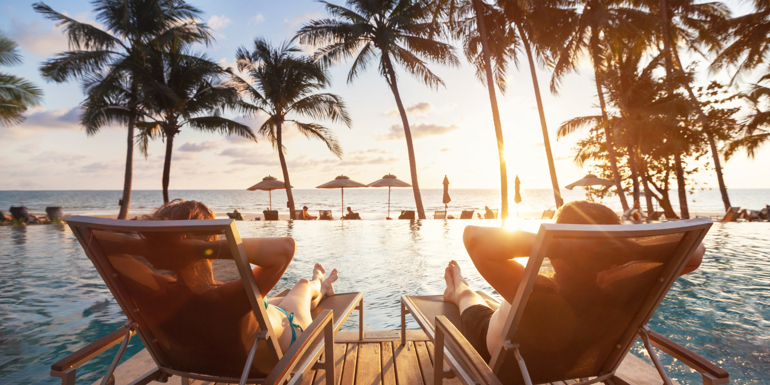 Couple at the beach relaxing looking at sunset